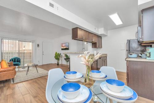 a kitchen and living room with a table and chairs at Spacious-2BR2BA- King Ensuite- PVT Patio in Houston