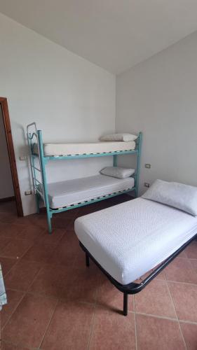 a room with two bunk beds and a mattress at Casa Antonietta in Santa Lucia