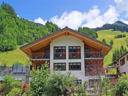 a large building with a mountain in the background at Apartment Künzel by Interhome in Schröcken