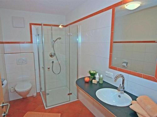 a bathroom with a shower and a sink and a toilet at Apartment Höfer by Interhome in Schröcken