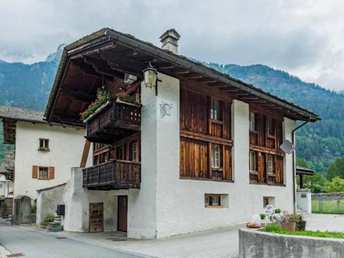 a building with wooden balconies on the side of it at Apartment Wohnung Muntegn by Interhome in Vicosoprano