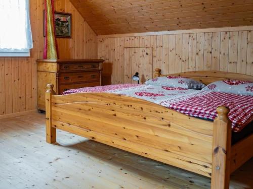 a bedroom with a wooden bed in a cabin at Apartment Haggen by Interhome in Oberegg