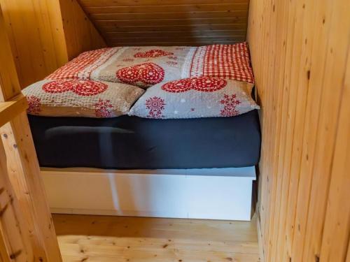 a small bed with two pillows on top of it at Apartment Haggen by Interhome in Oberegg