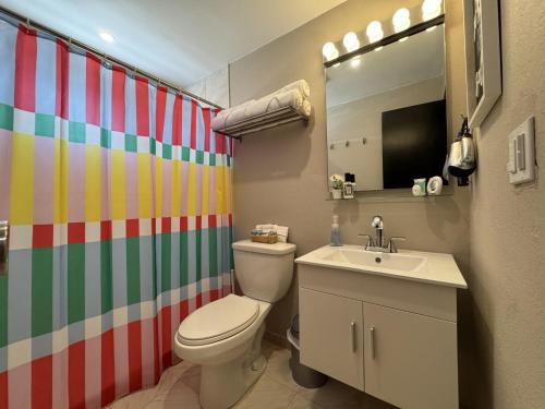 a bathroom with a toilet and a sink at Fontana Sunset - Spacious 3BR Family Home in Carolina