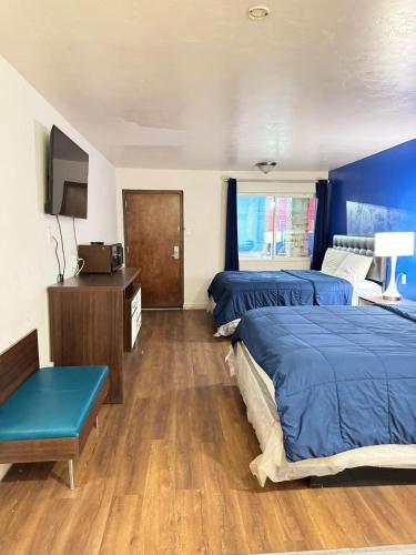 a hotel room with two beds and a tv at Alien Residence Inn in Pecos