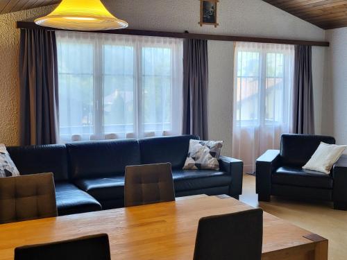 a living room with a couch and a table at Apartment Tgèsa Val by Interhome in Sedrun