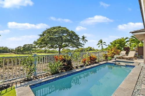 a swimming pool in front of a fence at Kona Blue Vacations Holua Kai in Kailua-Kona