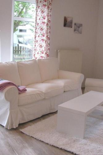 a white couch in a living room with a window at Apartment Florö by Interhome in Putbus