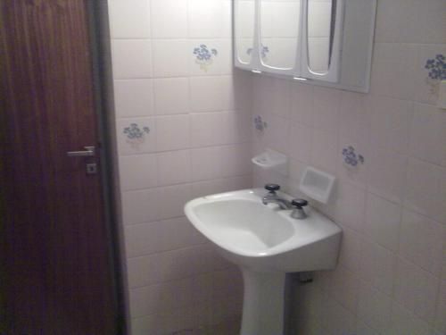 a white bathroom with a sink and a mirror at SAN CLEMENTE RIAZOr 6 in San Clemente del Tuyú