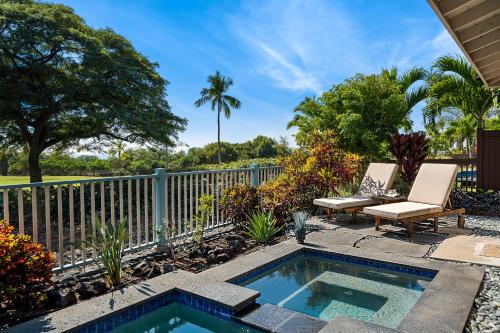 a backyard with a swimming pool with a chair and a bench at Kona Blue Vacations Holua Kai in Kailua-Kona