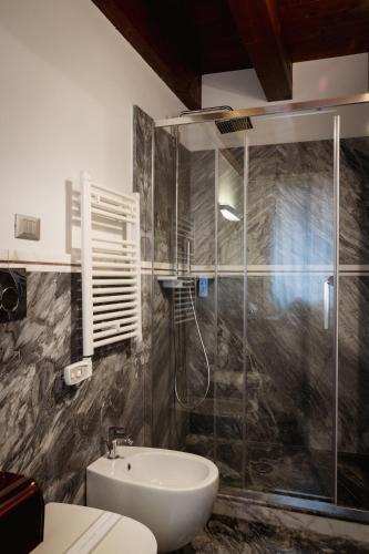 a bathroom with a sink and a glass shower at Piccola Venezia Room in Chioggia