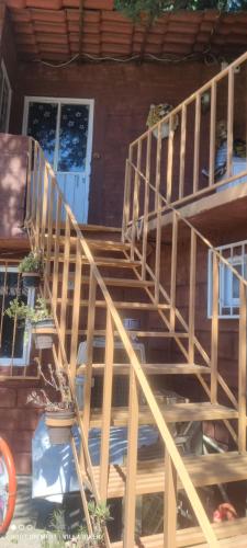 a wooden staircase in front of a house at Posada "Villa Biker" in Villa del Carbón