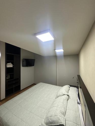 a bedroom with a bed and a television in it at Urban II - Cómodo monoambiente en pleno centro in San Juan