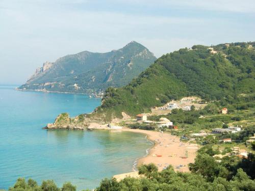 a view of a beach with people on it at Pool Apartments with panoramic Pelekas Beach view in Pelekas