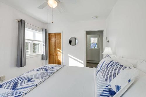 a white bedroom with a bed and a window at Unbeatable Downtown Location! Bar Harbor Apt in Bar Harbor