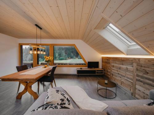 a living room with a table and a couch at Apartment Hof Obertalgut by Interhome in Teuffenthal