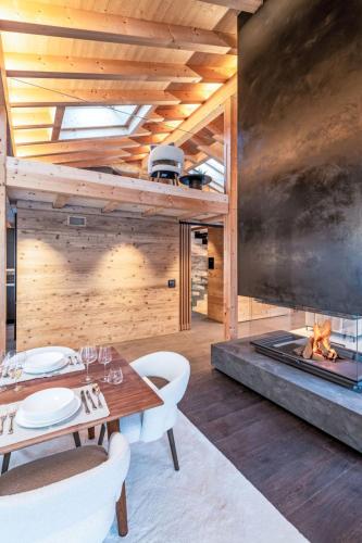 a dining room with a fireplace and a table and chairs at Chalet Chalet Andra by Interhome in Grindelwald