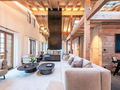 a living room with a white couch and tables at Chalet Chalet Andra by Interhome in Grindelwald