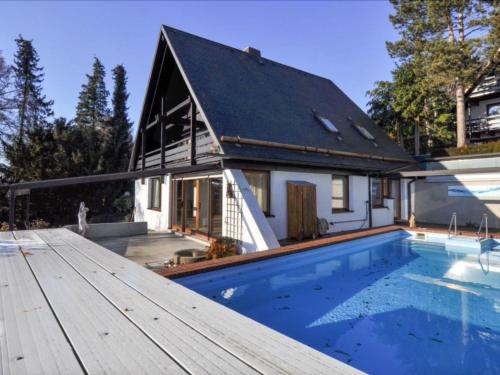 a house with a swimming pool in front of a house at Holiday Home mit Pool by Interhome in Nürtingen