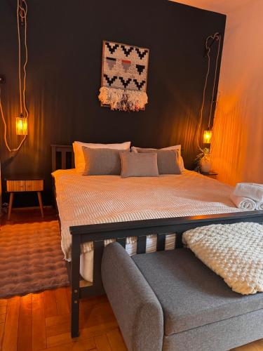 a bedroom with a bed and a couch at The Nest, Apartament in Oświęcim