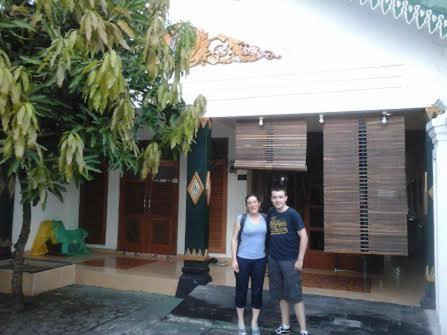 a man and woman standing in front of a building at Rumah Desa Homestay in Prambanan