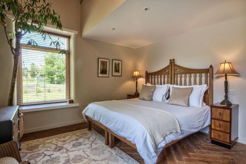 a bedroom with a large bed and a window at Olive Orchard in Cropredy