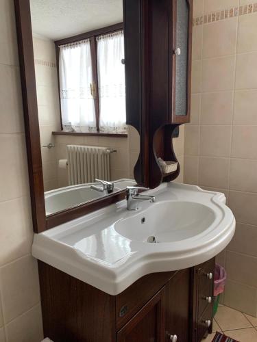 a bathroom with a white sink and a mirror at Albergo Martinet in Vernante