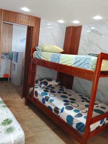 a bedroom with two bunk beds in a room at CRIMIg in Huamboya