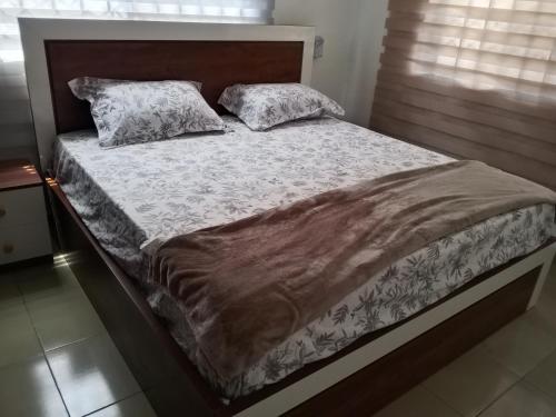 a bed with two pillows on it in a bedroom at El-Edu Villa in Oshien