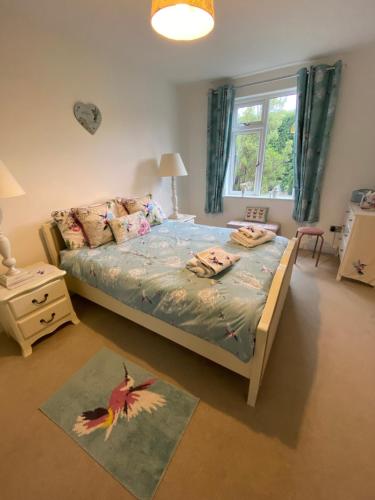 a bedroom with a bed and a window at Hare Lodge in Woodhall Spa