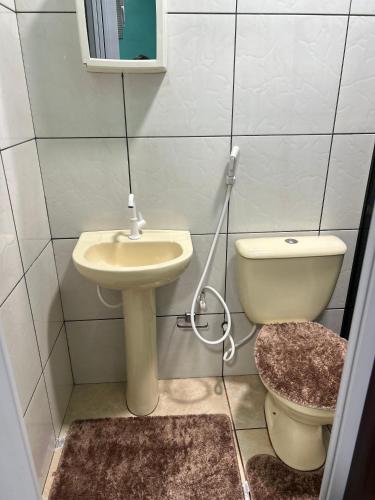 a bathroom with a sink and a toilet at Pousada Vitória in Iranduba