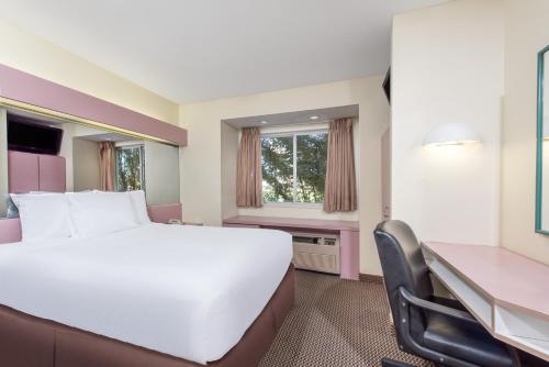 a hotel room with a large bed and a desk at Knights Inn Allentown in Allentown
