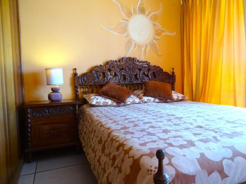 a bedroom with a large bed with a sun on the wall at Reñaca - Primera linea de playa con gran terraza in Viña del Mar