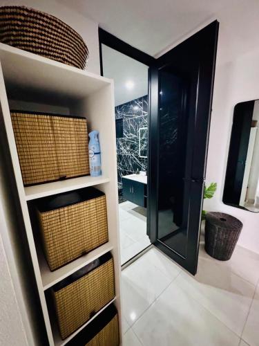 a bathroom with a walk in closet with baskets at Brand New Luxe 2BR Apt Near SJU & Airport in Carolina