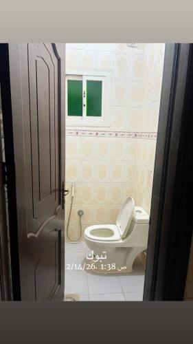 a bathroom with a toilet and a window at استوديو 104 in Tabuk