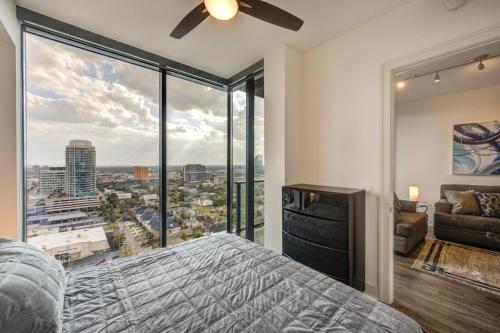 a bedroom with a bed and a large window at Hanover River Oaks in Houston