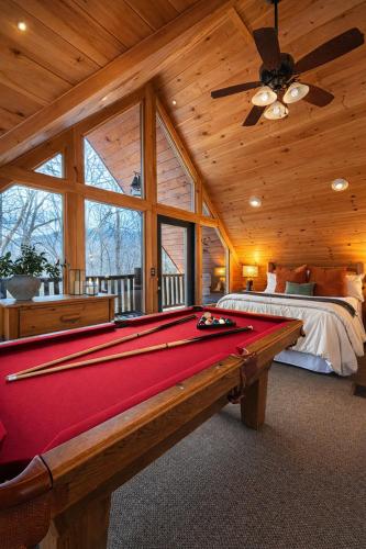 a pool table in a bedroom with a bed at Little Pine Lodge a Smokies Hideaway - 1 mi to GSMNP - King Suite & Loft, Fireplace, Hot Tub & BEARS! in Sevierville