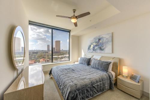 a bedroom with a bed and a large window at Hanover BLVD Place in Houston