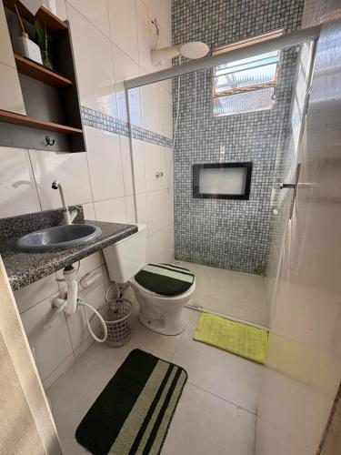 a bathroom with a shower and a toilet and a sink at CasadaKassia in Itapemirim