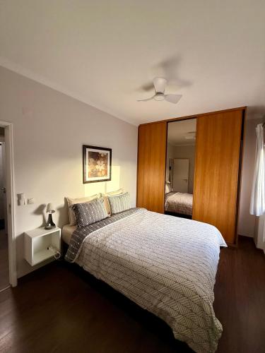 a bedroom with a large bed and a mirror at Apartamento Barão in Amora