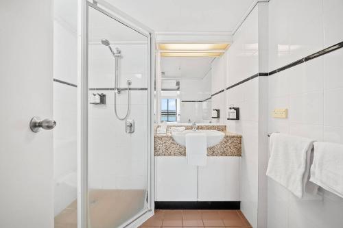 a bathroom with a shower and a sink at Lakefront Panorama – Classic in Canberra