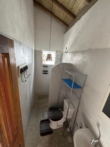 a small bathroom with a toilet and a sink at Casa Mojubá in Porto Seguro
