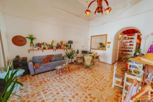 a living room with a couch and a table at Selva María Hotel Boutique in Santa Fe de Antioquia