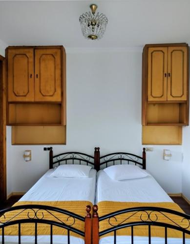 a bedroom with a bed and wooden cabinets at Discover Kinchkha in Satsiskvilo