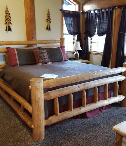 a bedroom with a wooden bed in a room at Nature's Inn Bed and Breakfast in Ahwahnee