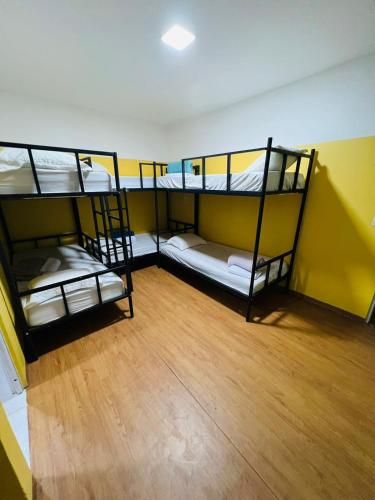an overhead view of a room with three bunk beds at Hostel Cünhatã in Belém