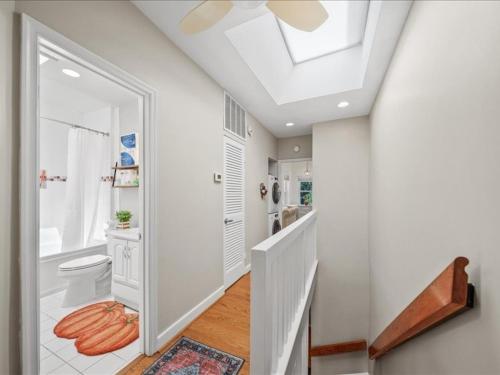 a white bathroom with a toilet and a skylight at May House in Washington, D.C.