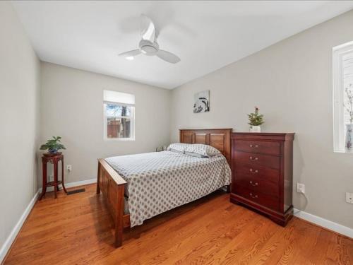 a bedroom with a bed and a dresser at May House in Washington, D.C.