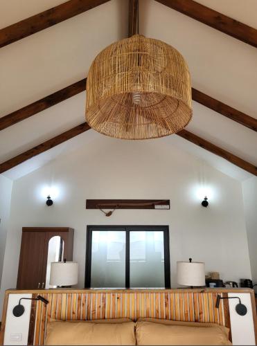 a room with a couch and a chandelier at Bokanbotin Island Resort in Majuro