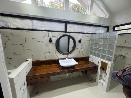 a bathroom with a mirror and a sink at Bokanbotin Island Resort in Majuro
